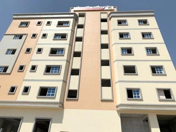 Apartment block painted in peach and cream